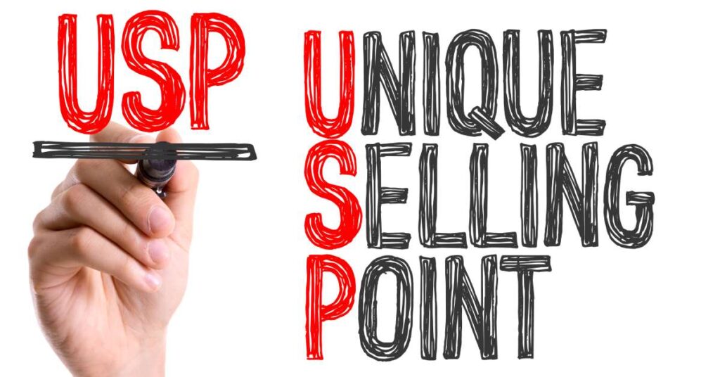 A hand with a whiteboard marker writes about the Unique Selling Point (USP), an important phrase in the advertising industry.