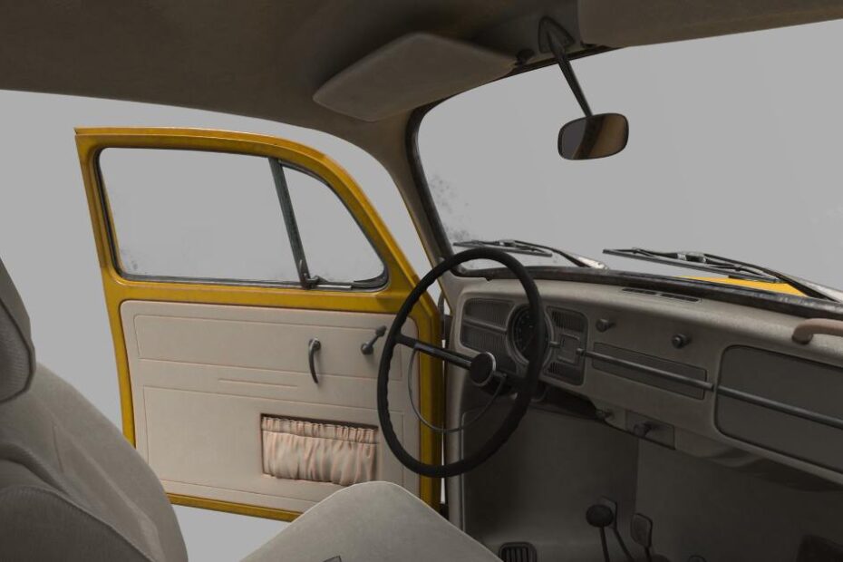 The interior of a classic car with neutral beige interior and yellow paint on the outside. The driver-side door is open.